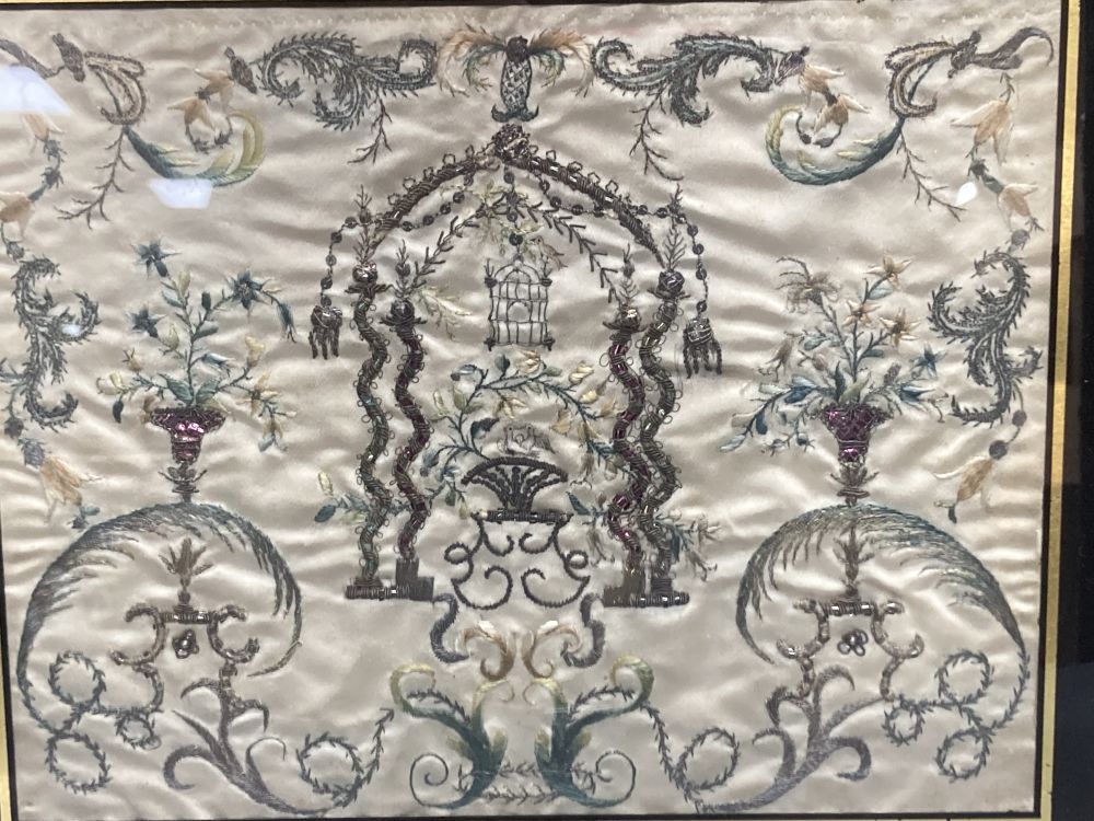 A Regency silk panel, embroidered with a bird cage and scrolling flowers and foliage, framed, 29 x 35cm